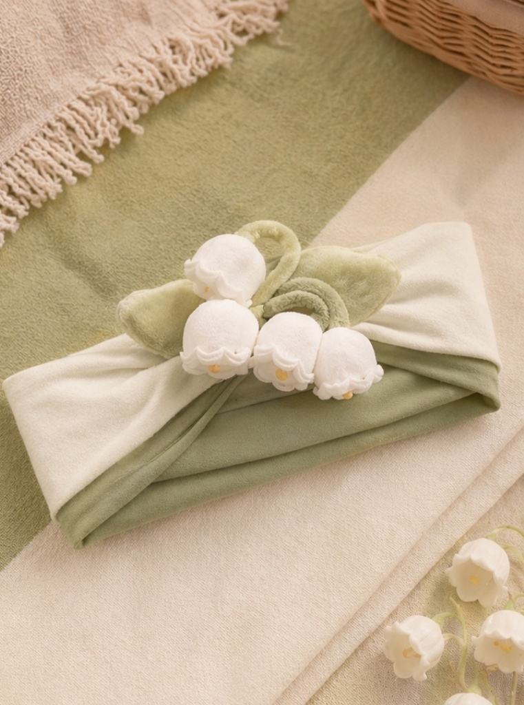 Banda para bebé con lirio del valle de peluche para líneas regalo y colecciones boutique de estilo natural