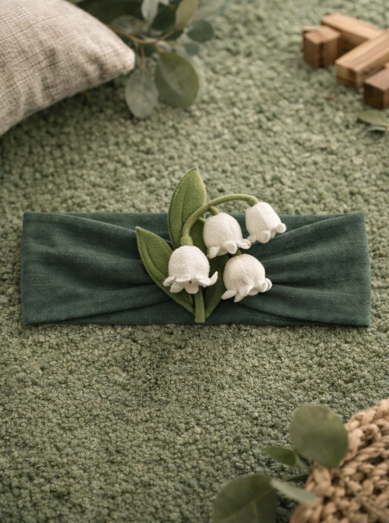 Banda para bebé con lirio del valle de peluche para colecciones naturales y fuerte atractivo visual en boutique
