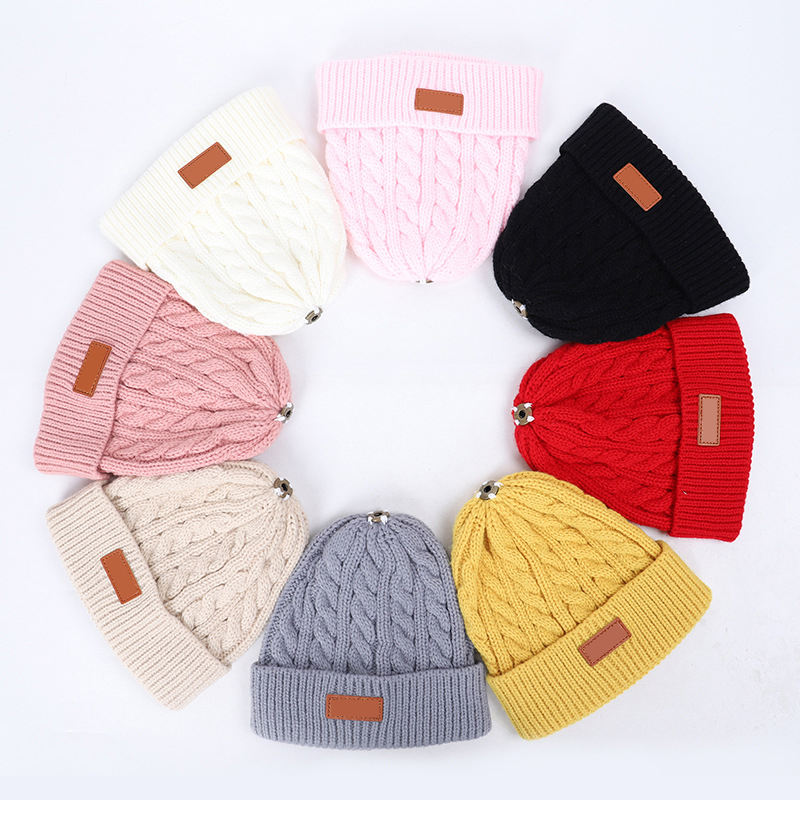 Women's Chunky Cable Knit Beanie Hat with Faux Fur Pom Pom and Leather Patch