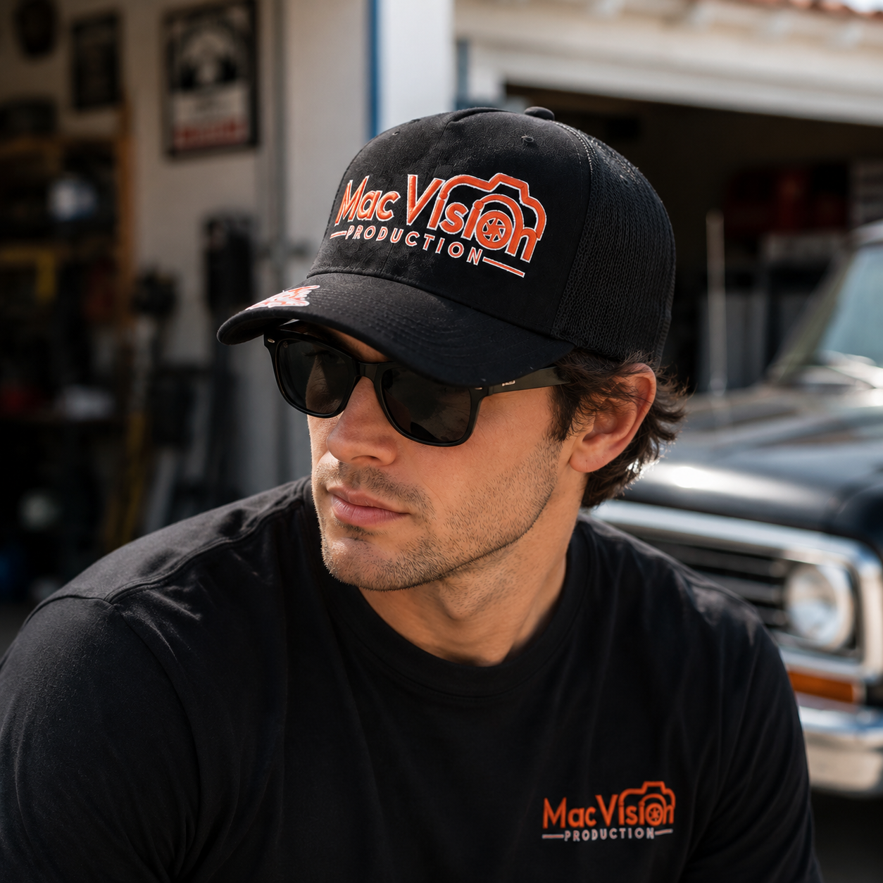 Black Mesh Trucker Cap with Orange Camera Logo Embroidery