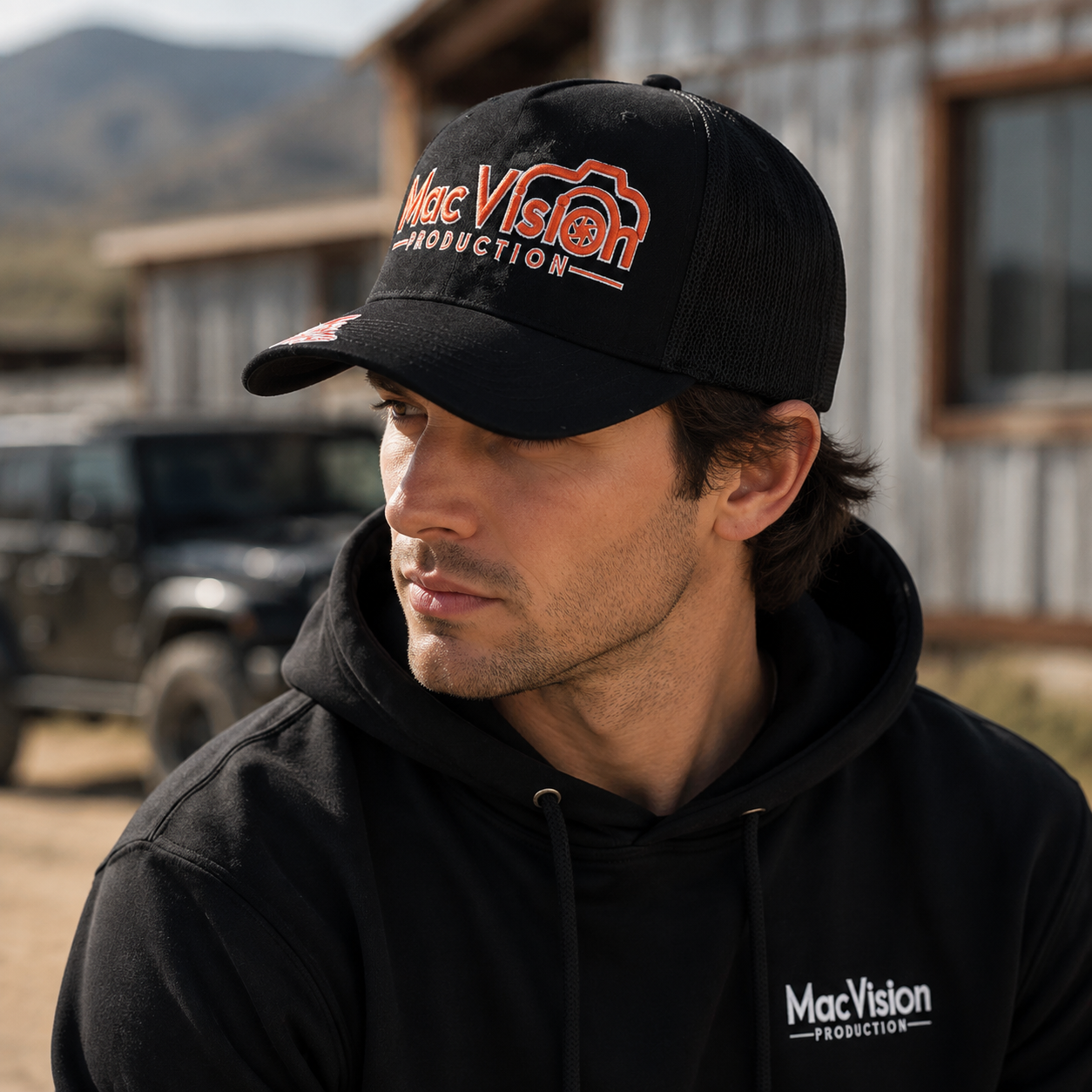 Black Mesh Trucker Cap with Orange Camera Logo Embroidery