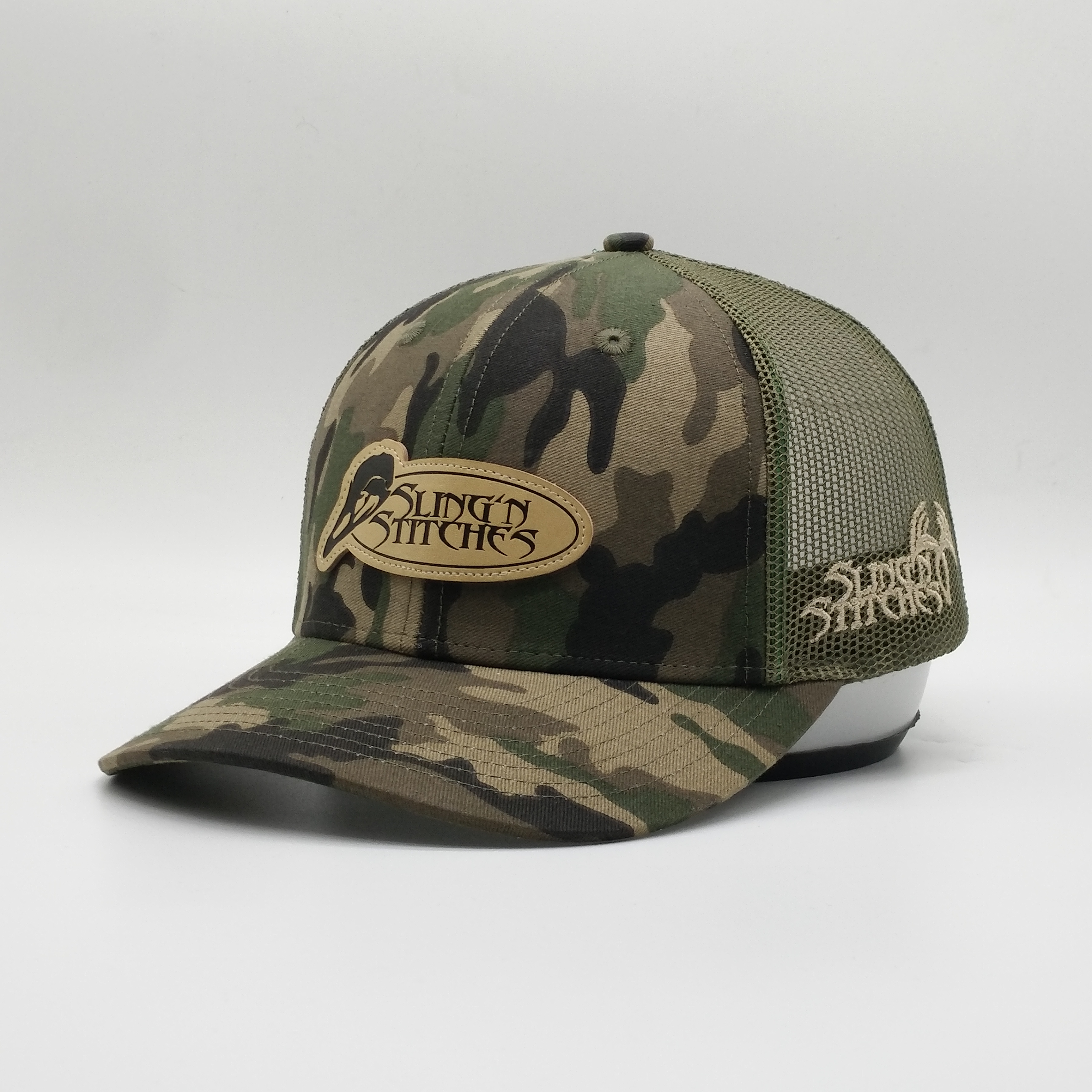 Camouflage Mesh Trucker Hat with Oval Leather Patch - Sling’n Stitches Logo Cap