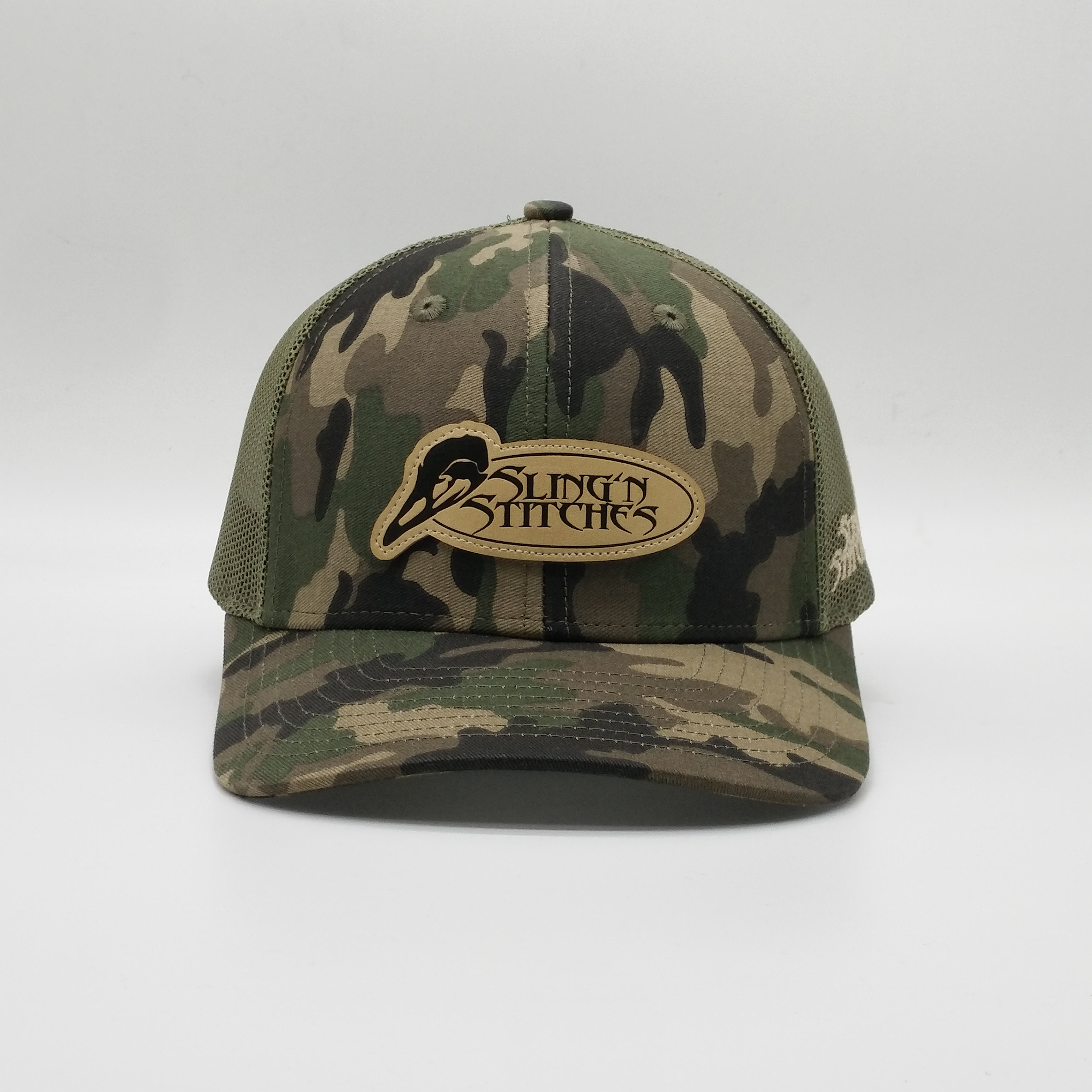 Camouflage Mesh Trucker Hat with Oval Leather Patch - Sling’n Stitches Logo Cap