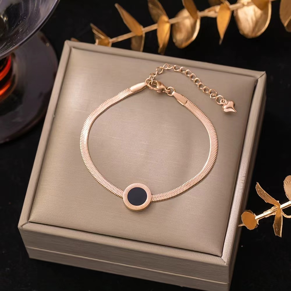 Elegant Gold Bracelet with Black Circular Pendant