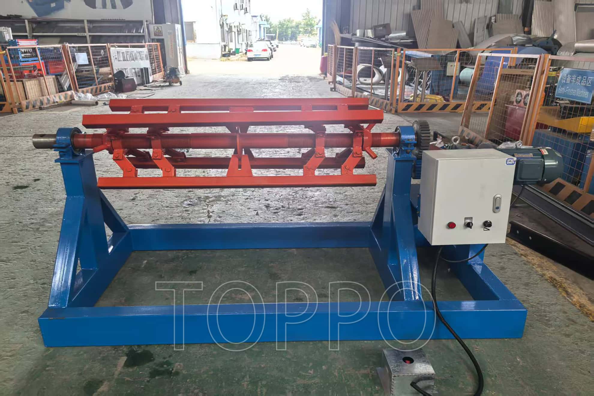 Electric Decoiler with Red Expansion Arm and Control Panel